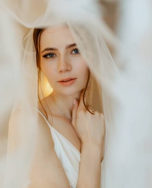 preparations for the bride with the dressing of the wedding dress in the studio